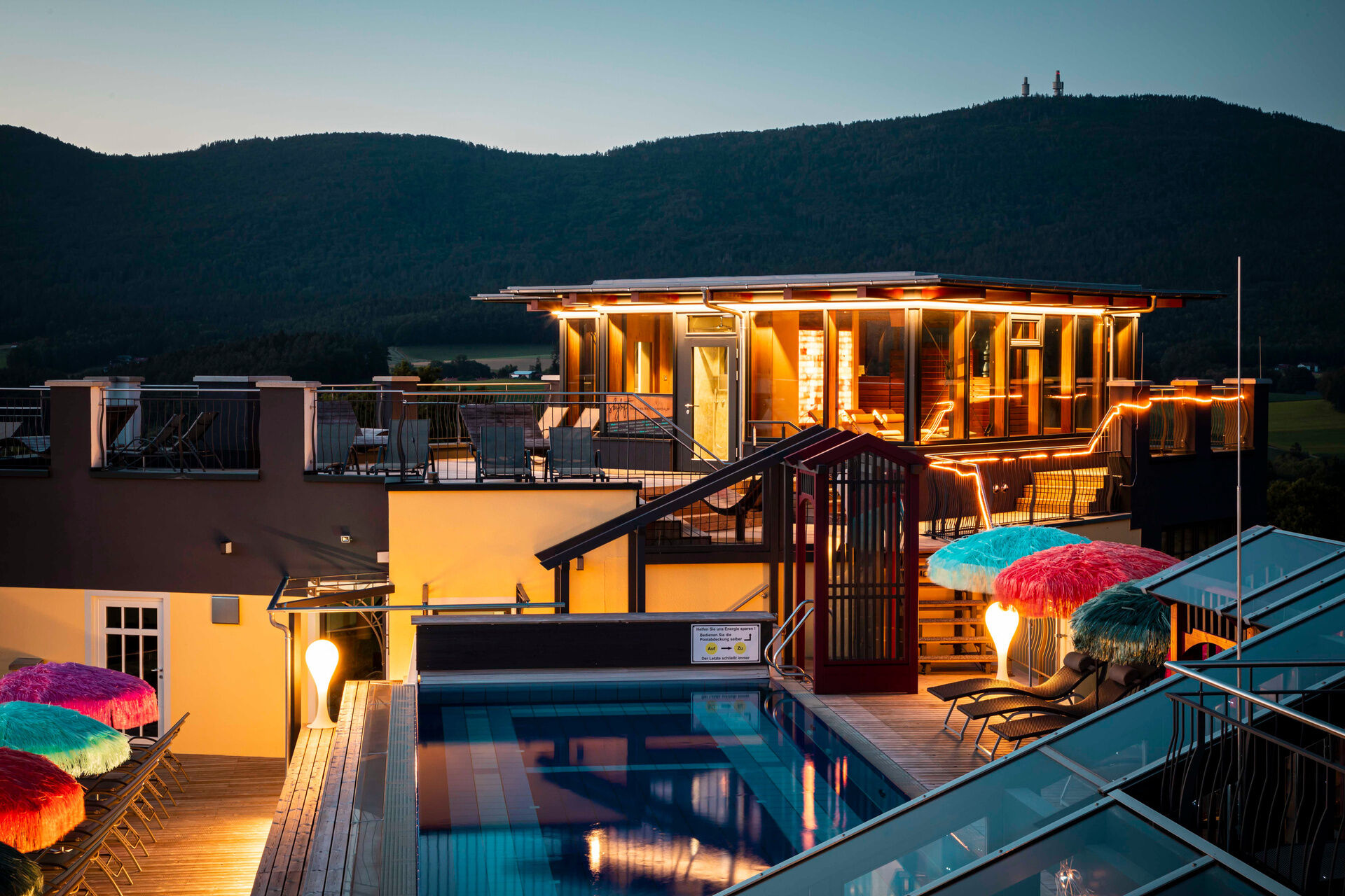 Beleuchtetes Dachpool-Deck in Abenddämmerung